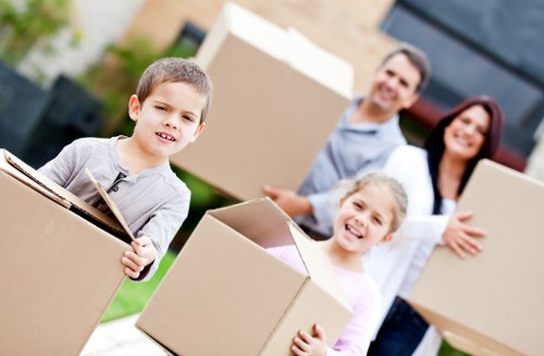 Packed moving boxes and furniture ready for transport in Sands End