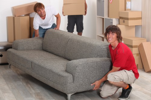 Packed moving boxes and furniture ready for transport in Sands End