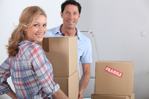 Local movers carrying furniture in a Sands End apartment building